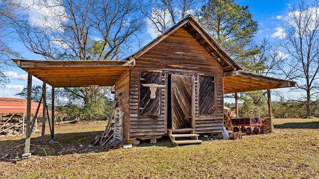 view of outbuilding with a yard