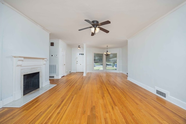 1712 Marilon Dr, Columbus, GA 31906 - unfurnished living room with crown molding, a ceiling fan, a premium fireplace, a chandelier, and light wood-type flooring