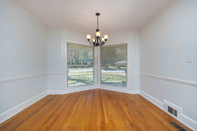 1712 Marilon Dr, Columbus, GA 31906 - empty room featuring a chandelier, crown molding, light wood finished floors, and baseboards