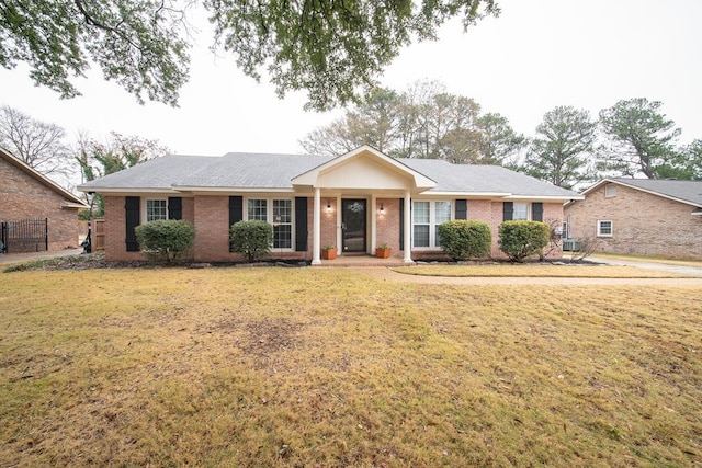 ranch-style home featuring a front yard