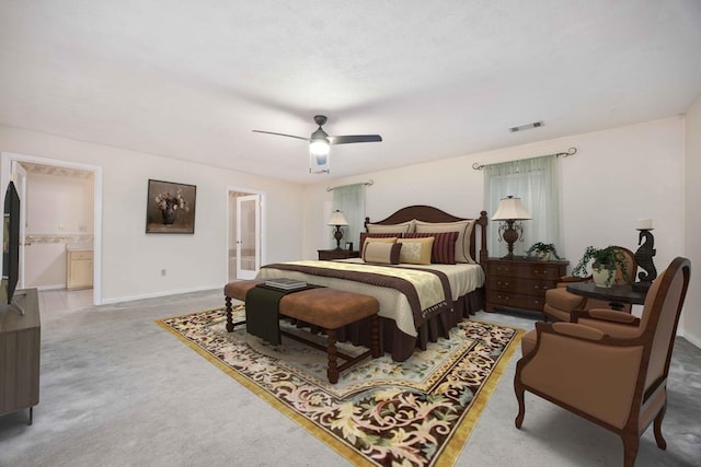 bedroom with a ceiling fan, baseboards, visible vents, and connected bathroom