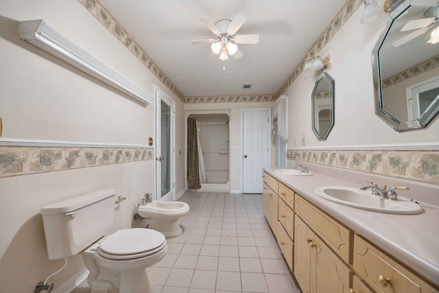 bathroom featuring a wainscoted wall, toilet, a sink, a shower stall, and tile patterned flooring