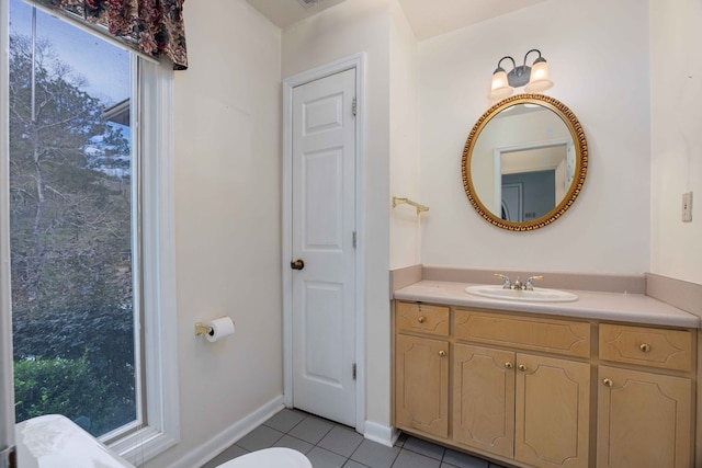 bathroom featuring vanity, baseboards, and tile patterned floors