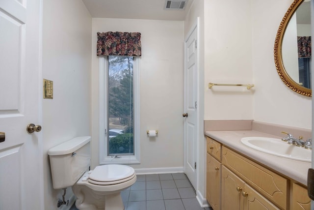 bathroom with tile patterned flooring, toilet, vanity, visible vents, and baseboards