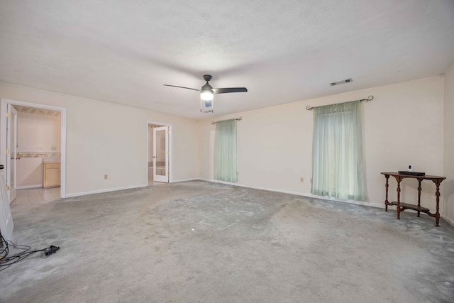 empty room featuring light carpet, baseboards, visible vents, and a textured ceiling