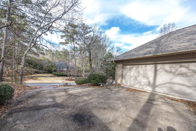 garage featuring aphalt driveway