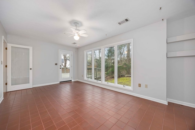 interior space featuring a ceiling fan, visible vents, and baseboards