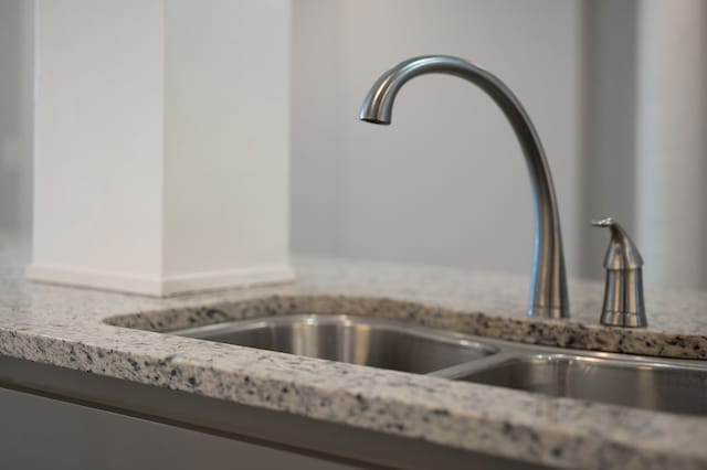 interior details featuring light stone countertops and a sink