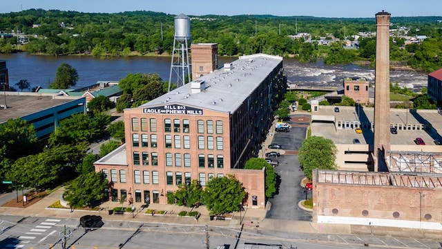 aerial view with a water view and a wooded view