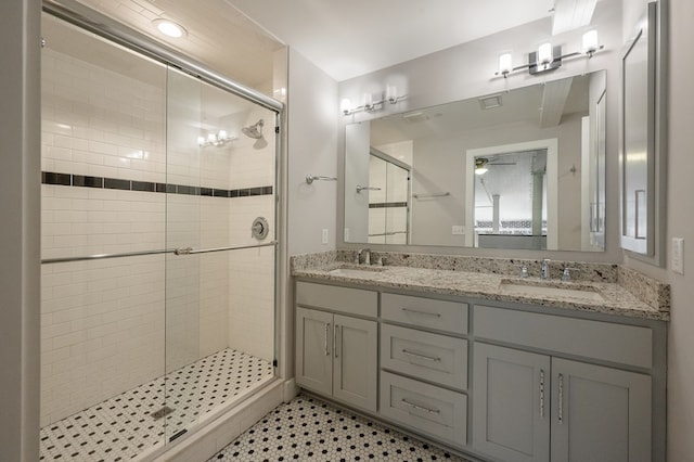 bathroom with a sink, double vanity, and a shower stall