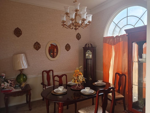 dining area with ornamental molding and an inviting chandelier