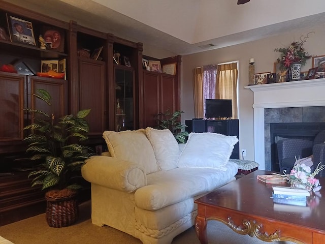 living room with a tile fireplace