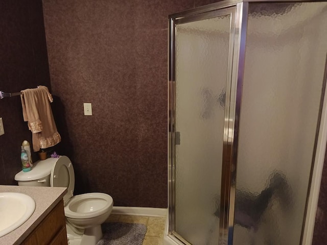 bathroom featuring vanity, tile patterned floors, a shower with door, and toilet