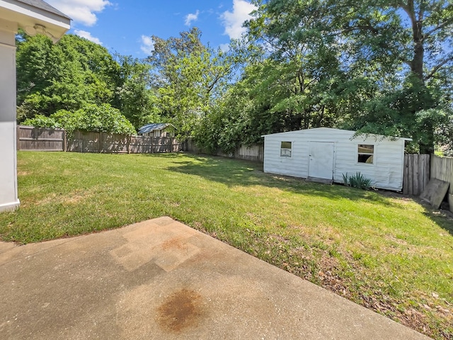 view of yard featuring a fenced backyard, a storage unit, an outdoor structure, and a patio