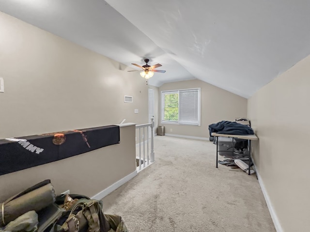 interior space featuring baseboards, a ceiling fan, light carpet, and lofted ceiling
