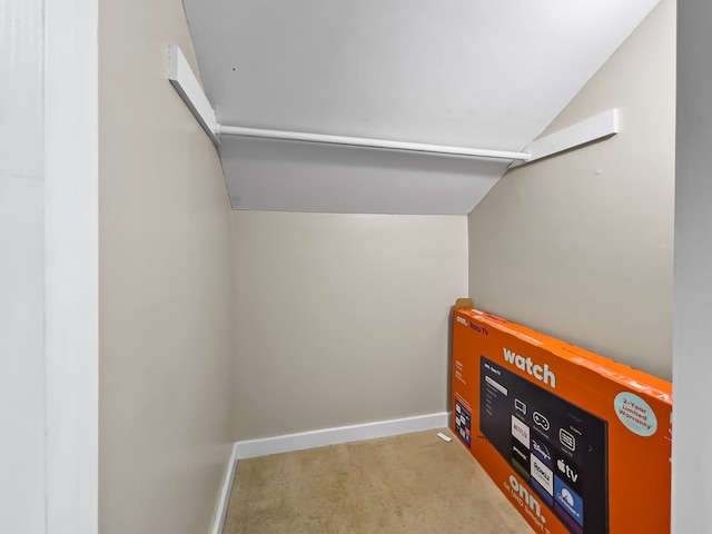 interior space with carpet, lofted ceiling, and baseboards