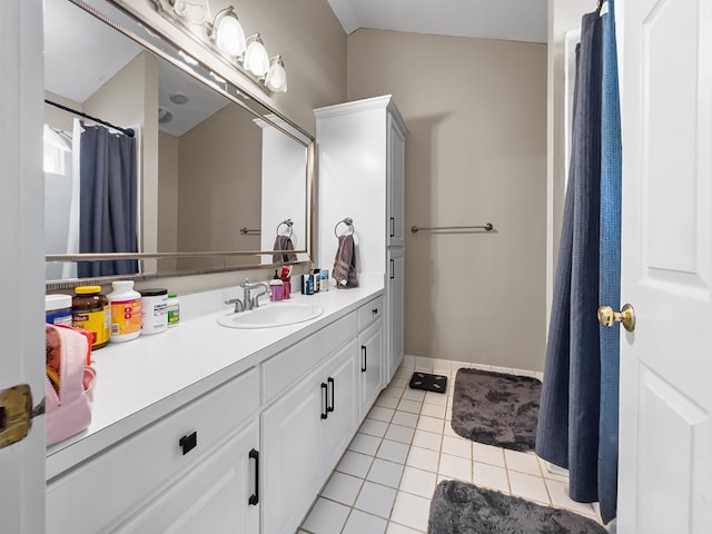 bathroom featuring tile patterned floors, baseboards, vanity, and curtained shower
