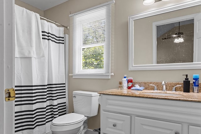 bathroom with a shower with shower curtain, toilet, and vanity