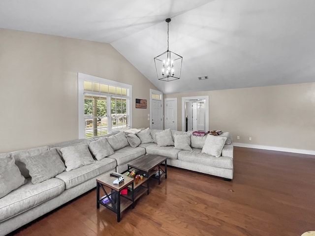 living area with wood finished floors, an inviting chandelier, baseboards, lofted ceiling, and visible vents
