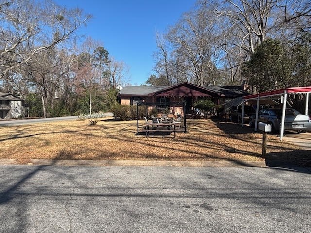 exterior space with a carport