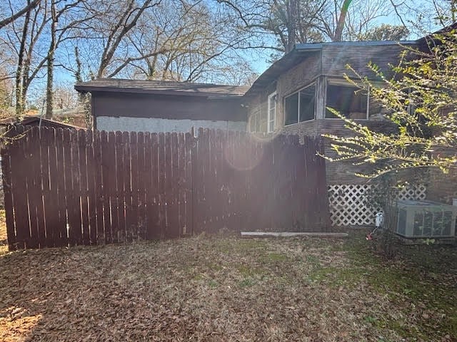 view of yard featuring cooling unit and fence