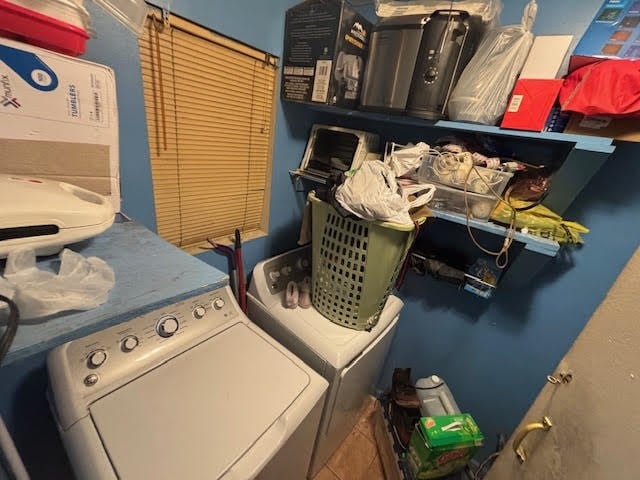 clothes washing area with tile patterned flooring, laundry area, and washing machine and clothes dryer