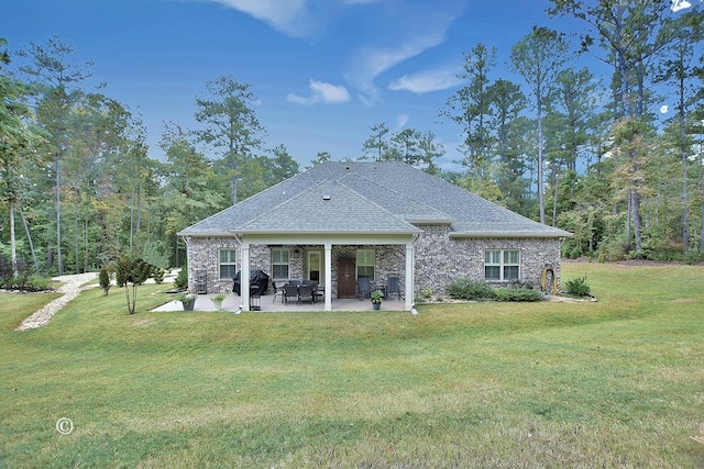 back of house featuring a lawn and a patio area