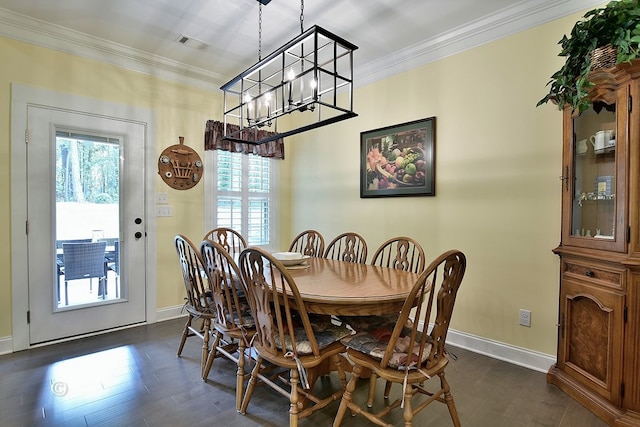 dining room featuring a notable chandelier, dark hardwood / wood-style flooring, and crown molding