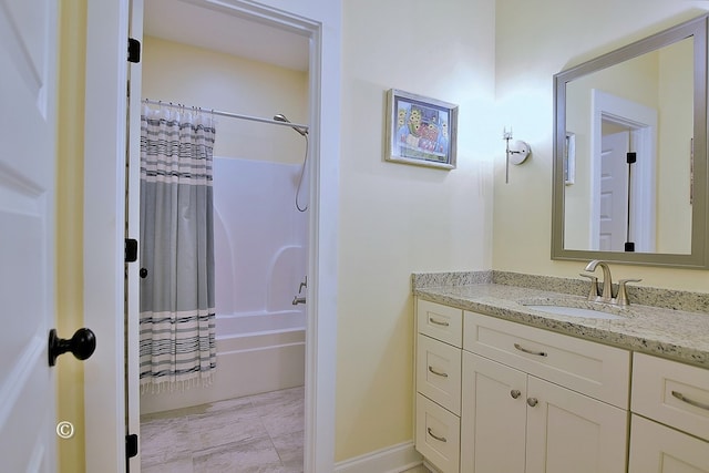 bathroom featuring shower / bath combo with shower curtain and vanity