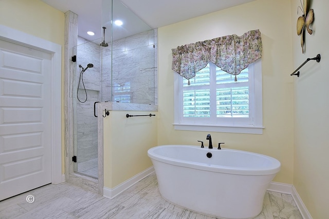 bathroom featuring shower with separate bathtub