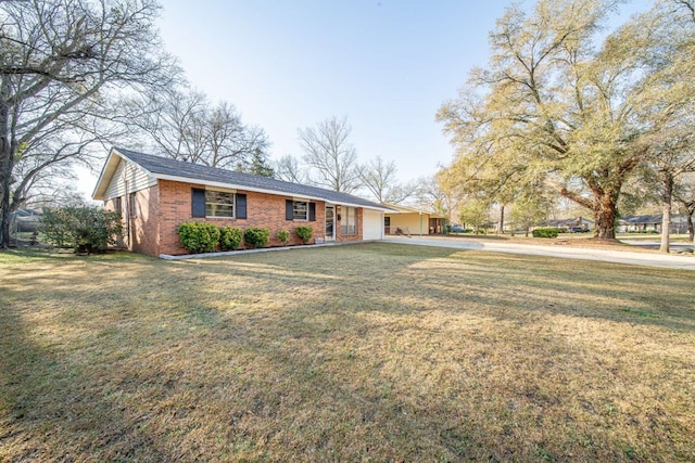 ranch-style house with a front yard and brick siding