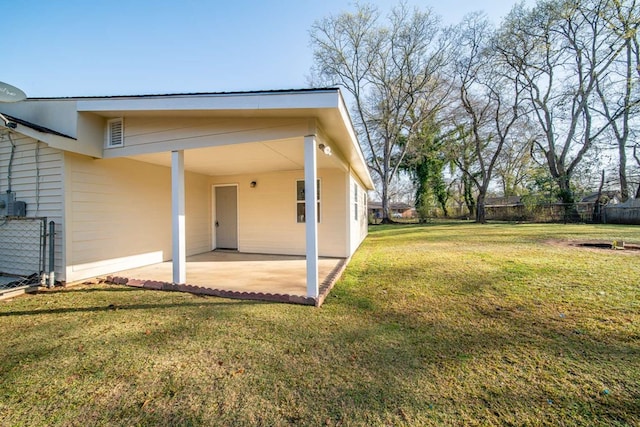 view of yard featuring a patio area, an attached carport, and fence