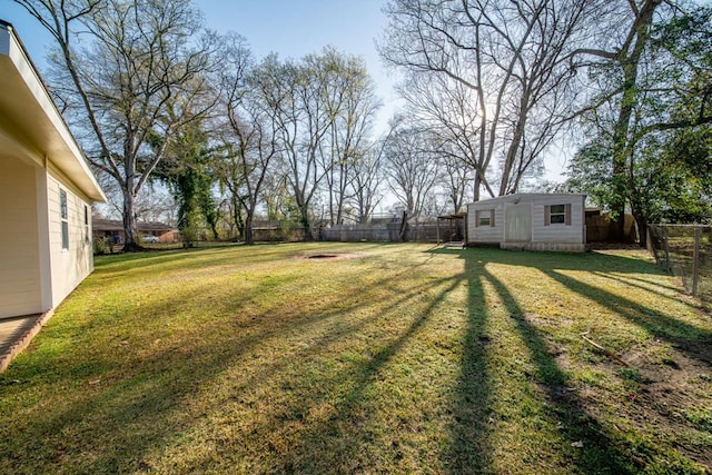 view of yard with an outbuilding and a fenced backyard