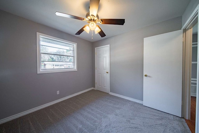 unfurnished bedroom with a ceiling fan, baseboards, and carpet floors