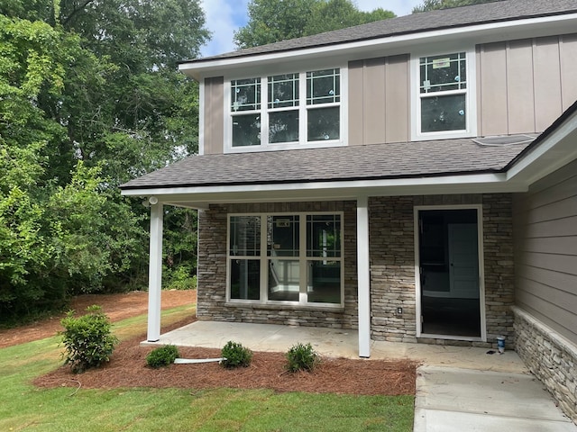 3077 Reese Rd, Columbus, GA 31907 - entrance to property featuring stone siding, board and batten siding, covered porch, and roof with shingles