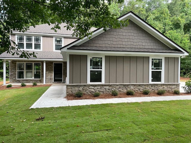 3077 Reese Rd, Columbus, GA 31907 - craftsman house featuring board and batten siding, a front yard, a shingled roof, and stone siding