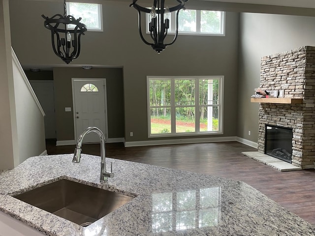 3077 Reese Rd, Columbus, GA 31907 - kitchen featuring a chandelier, a high ceiling, plenty of natural light, and light stone counters