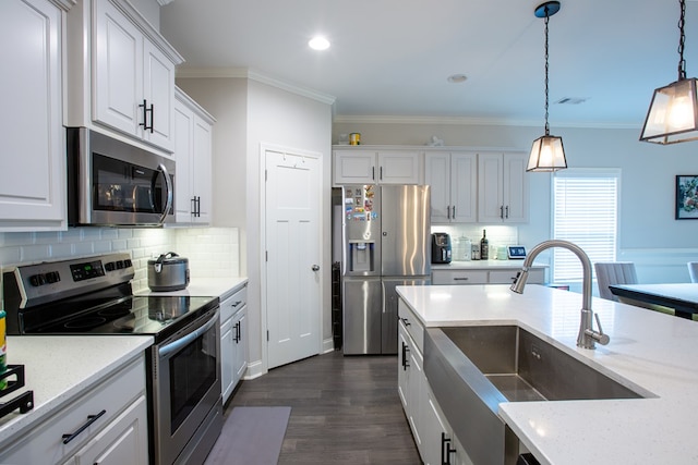 6845 Admiral Dr, Midland, GA 31820 - kitchen featuring ornamental molding, white cabinets, appliances with stainless steel finishes, a sink, and hanging light fixtures