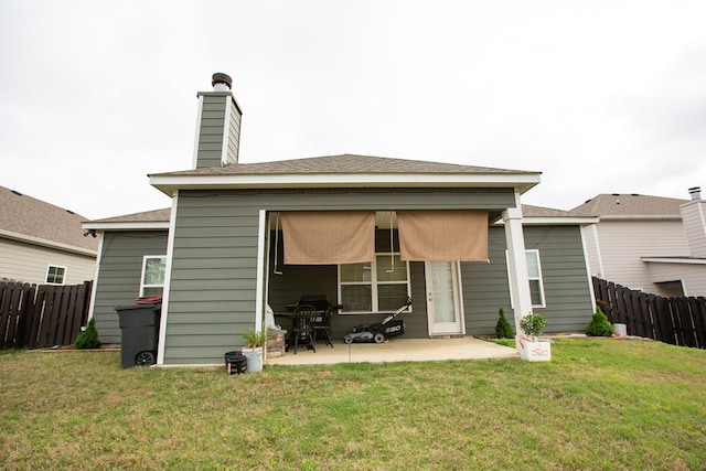 6845 Admiral Dr, Midland, GA 31820 - rear view of property featuring a patio, a chimney, fence, and a lawn