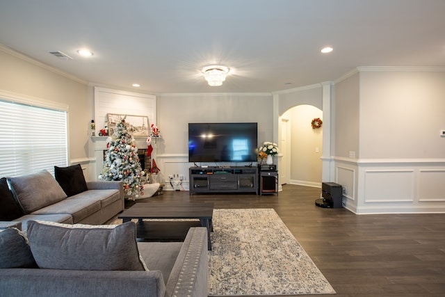6845 Admiral Dr, Midland, GA 31820 - living room with recessed lighting, dark wood-style floors, crown molding, a decorative wall, and arched walkways