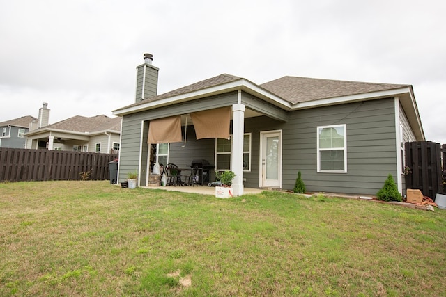 6845 Admiral Dr, Midland, GA 31820 - rear view of house with a yard, fence, a patio, and a chimney