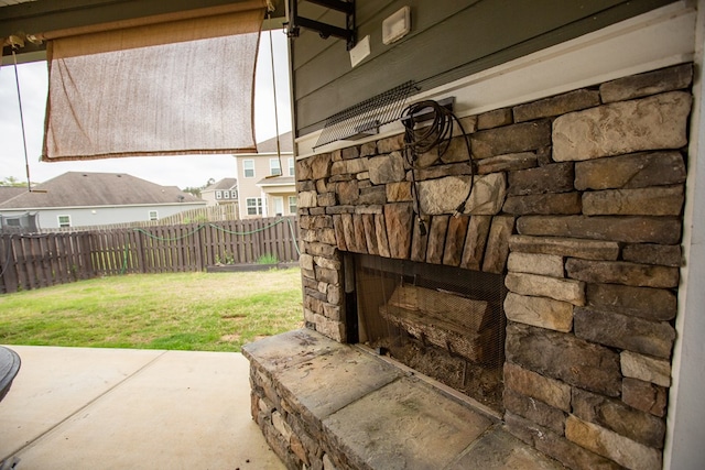 6845 Admiral Dr, Midland, GA 31820 - exterior details with a fenced backyard, an outdoor stone fireplace, and stone siding