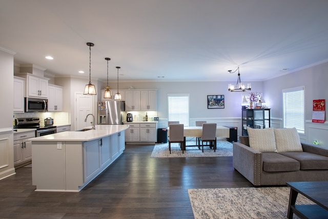 6845 Admiral Dr, Midland, GA 31820 - kitchen with appliances with stainless steel finishes, an inviting chandelier, light countertops, and white cabinetry