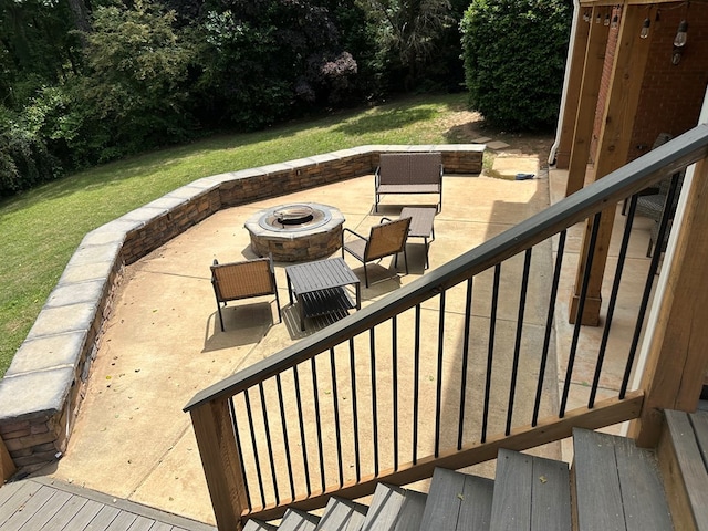 wooden terrace featuring an outdoor fire pit, a patio area, a yard, and stairway