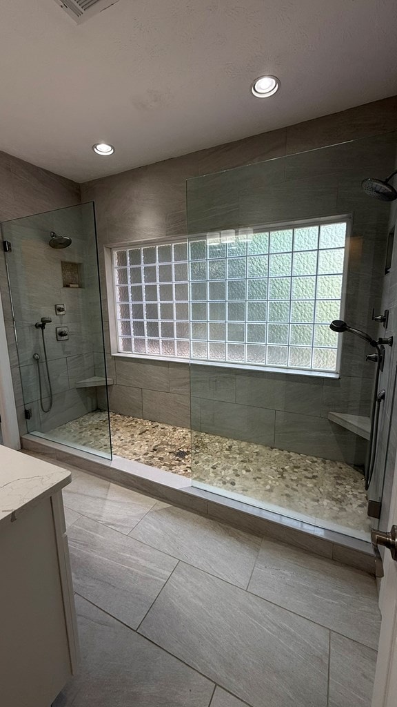 full bath featuring recessed lighting, walk in shower, tile patterned flooring, and vanity