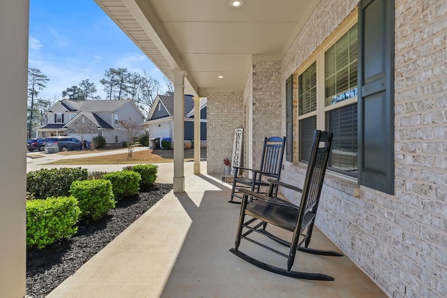 view of patio featuring covered porch and a residential view