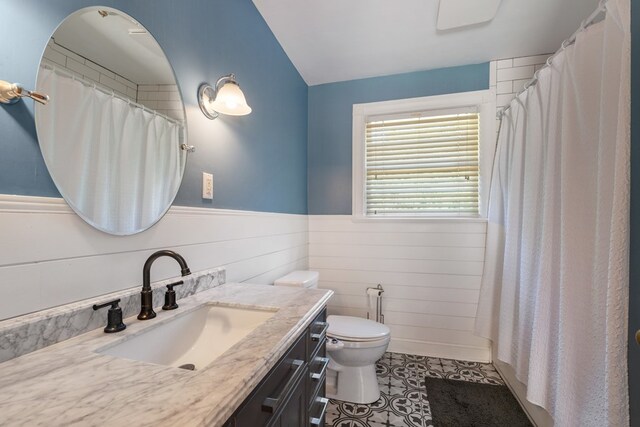 bathroom with tile patterned floors, vanity, curtained shower, and toilet