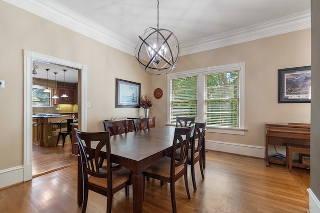 dining room featuring hardwood / wood-style flooring, crown molding, and an inviting chandelier