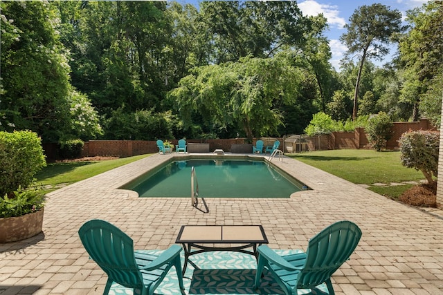 view of swimming pool with a yard and a patio