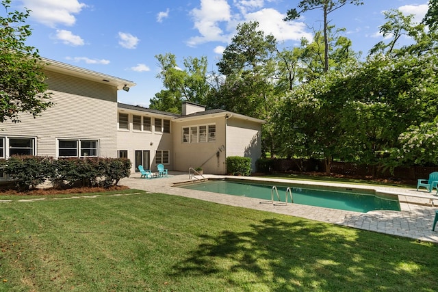 view of swimming pool with a lawn and a patio area